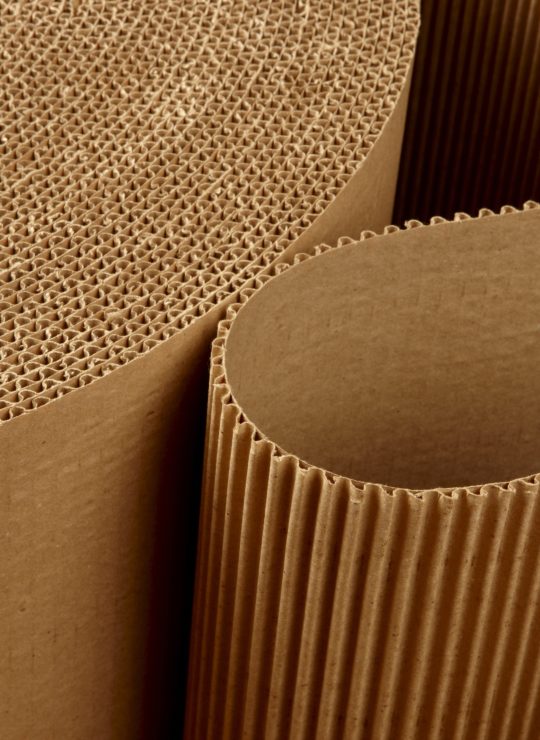 Close,Up,Shot,Of,Corrugated,Packing,Material,Uncurling,On,Black